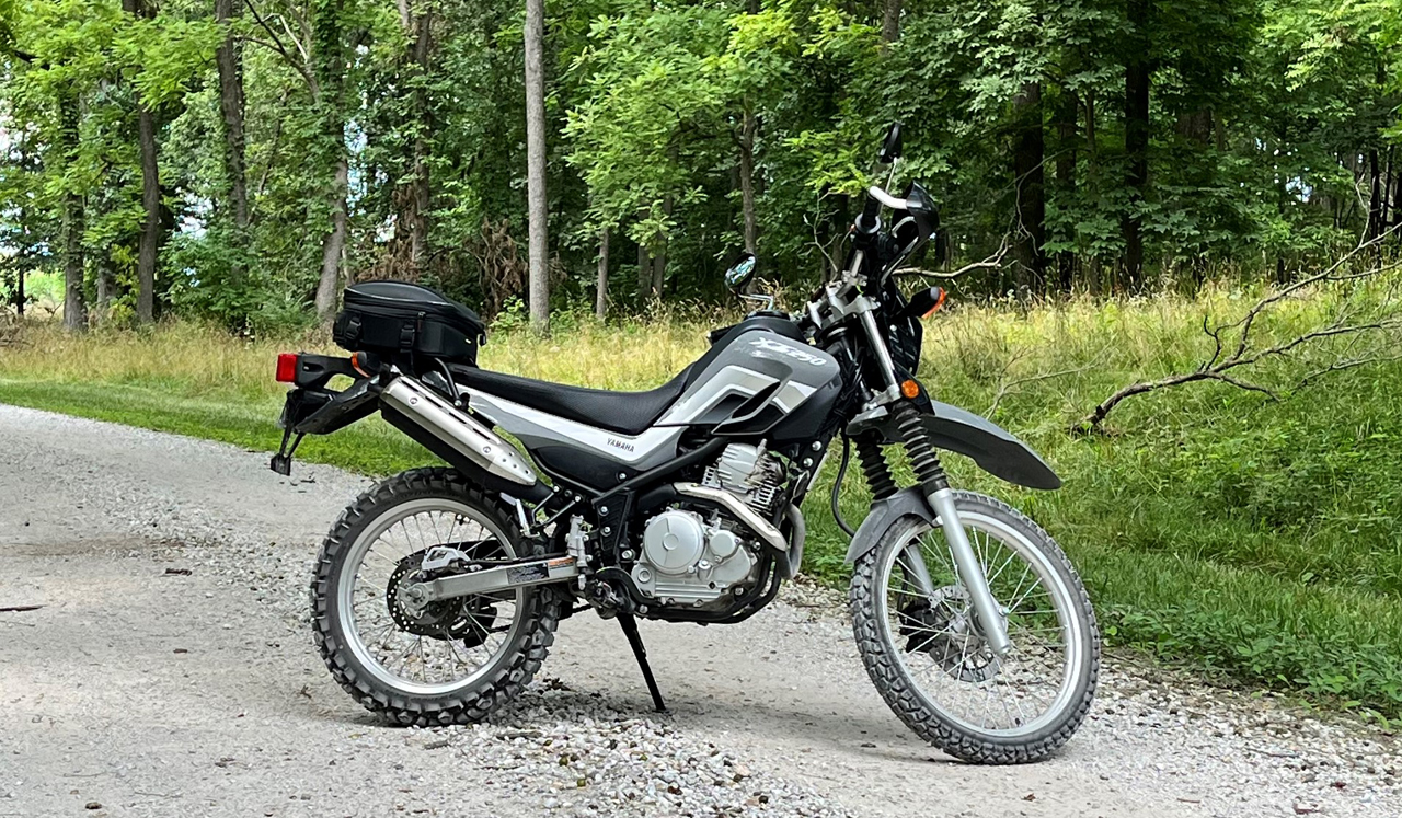 Yamaha XT250 gravel back road green forest