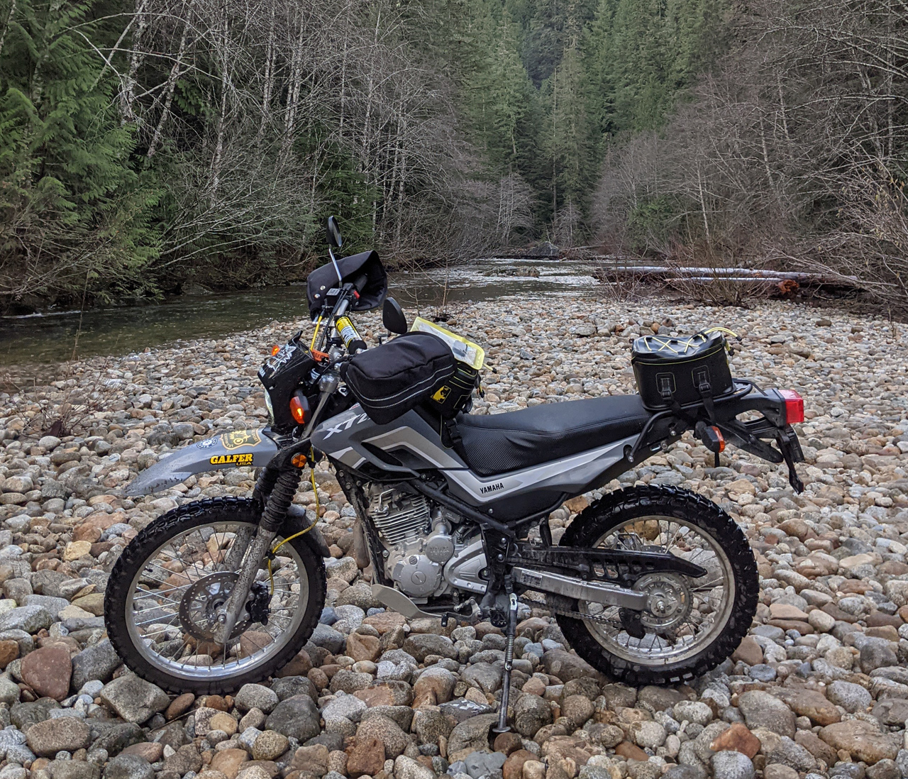 Yamaha XT250 round river rock forest paradise stream